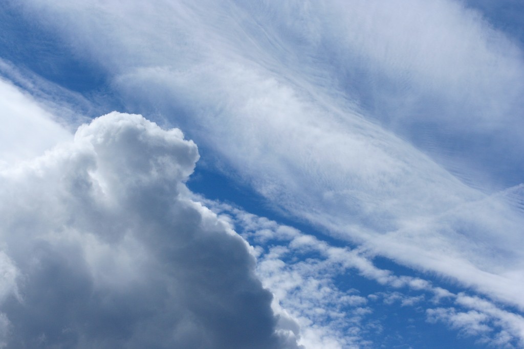  Cumulus, cirrocumulus and cirrostratus clouds share the sky on a summer afternoon