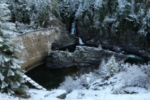 River rafters run the rapids through the gap on the east end of the dam (right side)