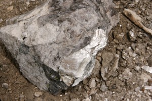 Muscovite (light-colored mica) is the flaky, shiny mineral on the lower right-hand corner of this rock