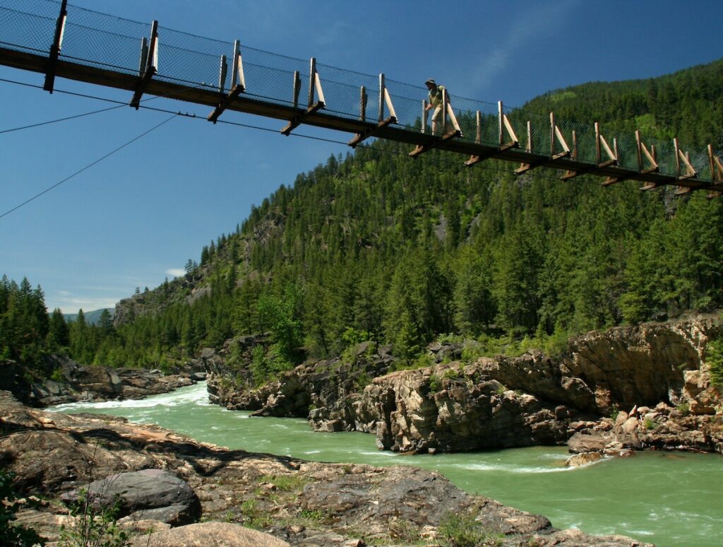 Swinging bridge over Kootenai River by Kootenai Falls